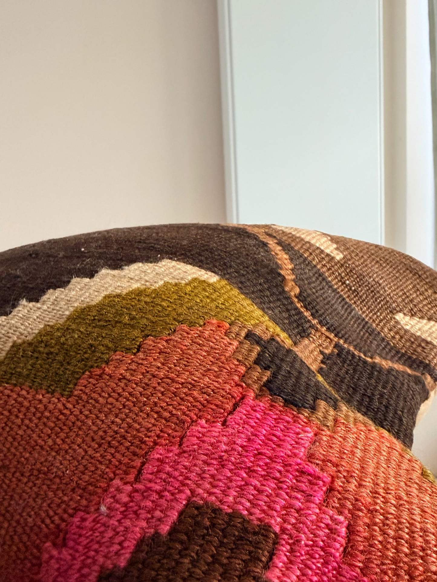 Unique hand-knotted kilim cushion featuring a large abstract geometric pattern in charcoal, moss green, and fuchsia
