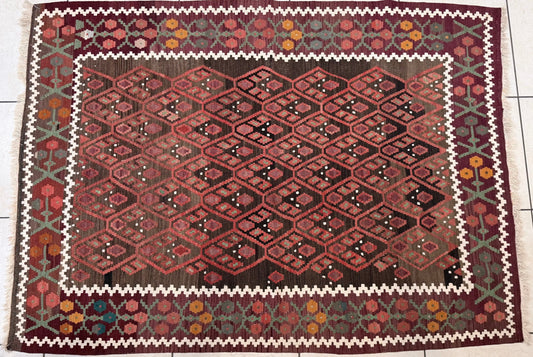 Anatolian rug with geometric pattern on a tiled floor