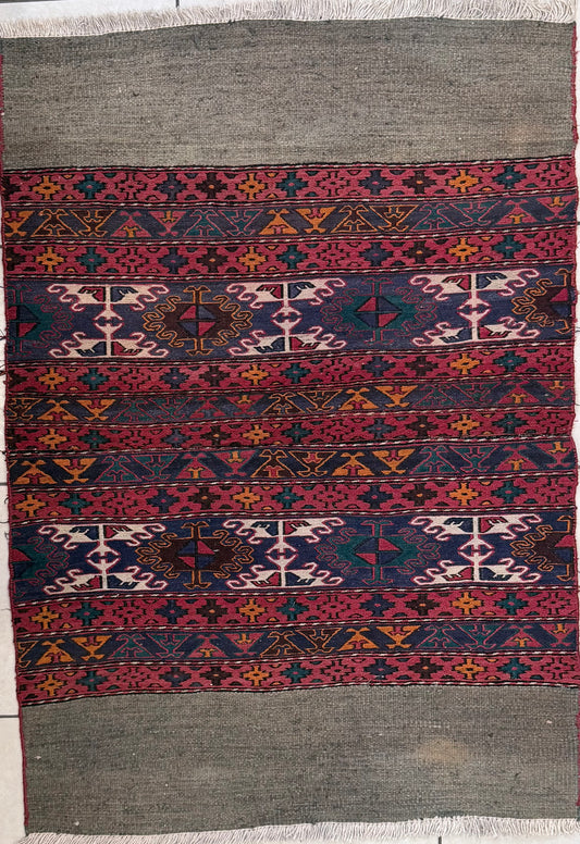 Handwoven wool rug with intricate motifs and abrash
