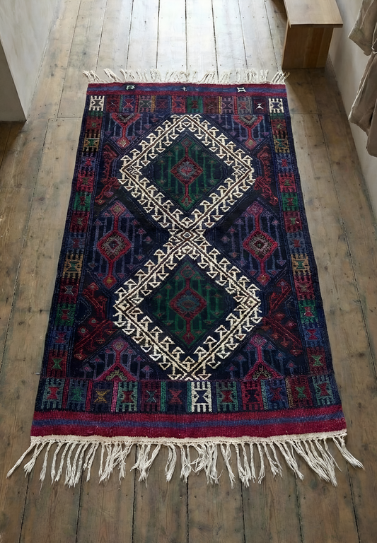 Anatolian kilim rug with geometric pattern on a wooden floor