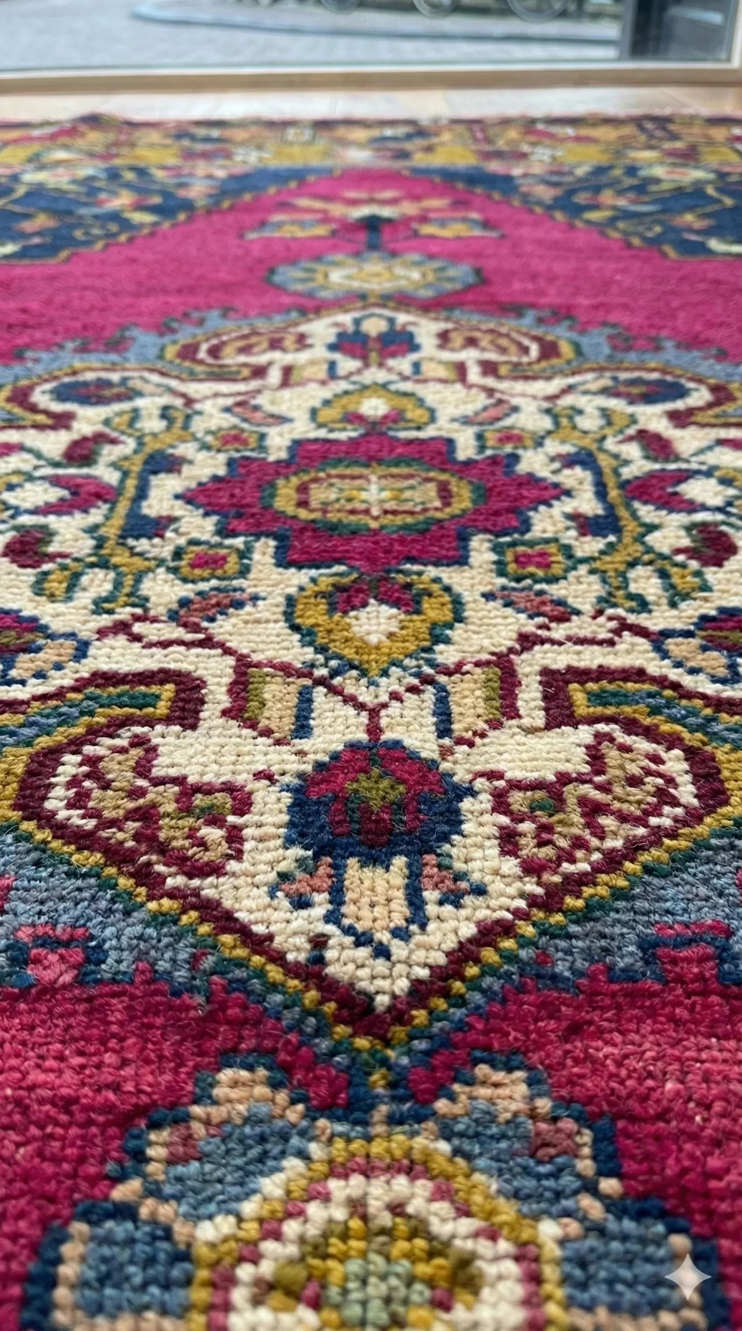 Colorful Anatolian rug with intricate designs on a wooden floor