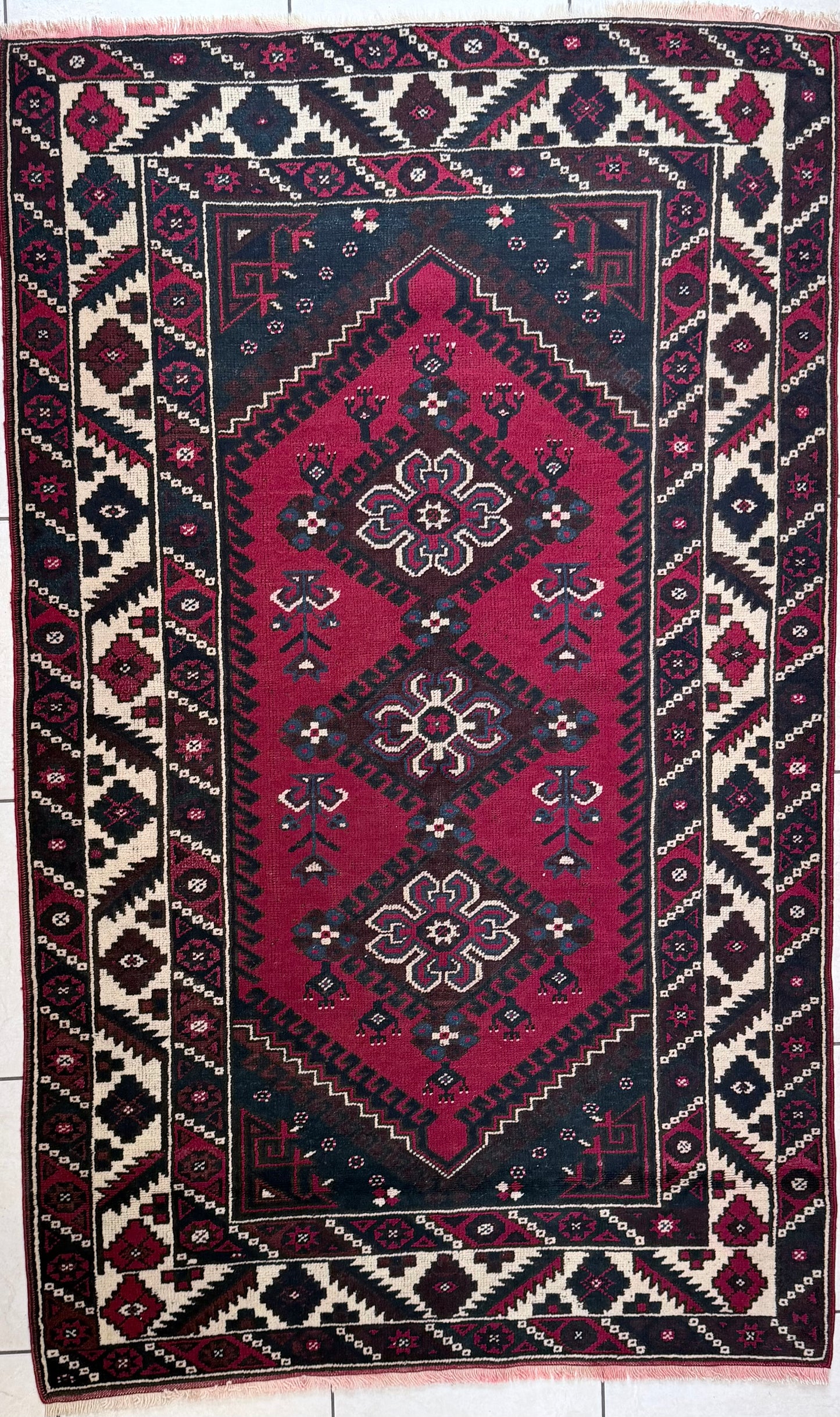 Handknotted wool rug in red, cream and charcoal