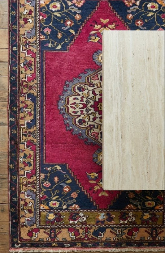 Anatolian wool rug with intricate patterns on a wooden floor