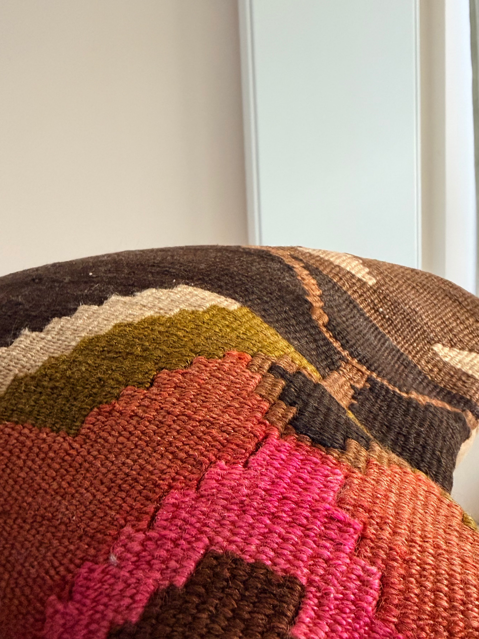 Unique hand-knotted kilim cushion featuring a large abstract geometric pattern in charcoal, moss green, and fuchsia