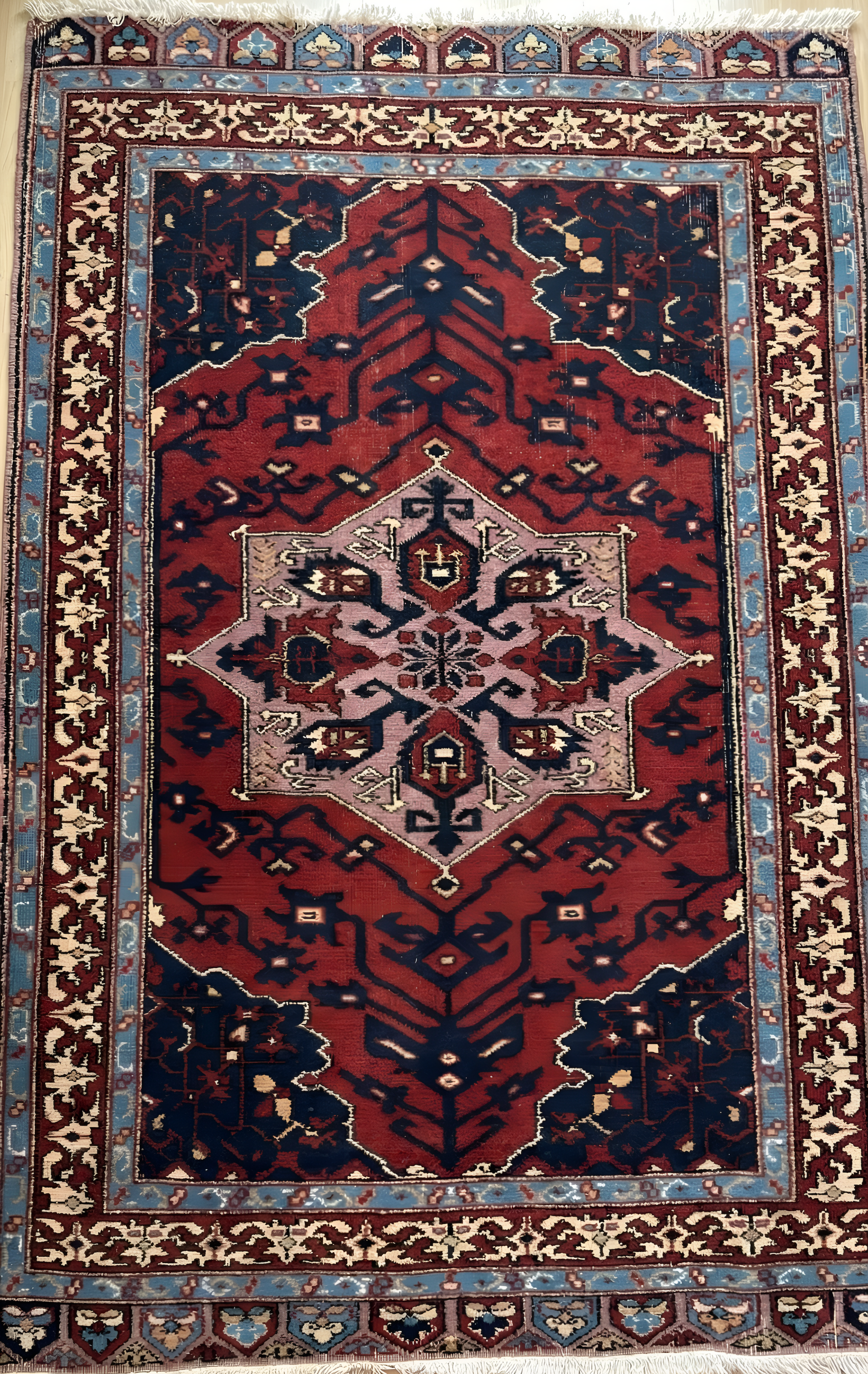 Anatolian wool rug with intricate patterns on a red background