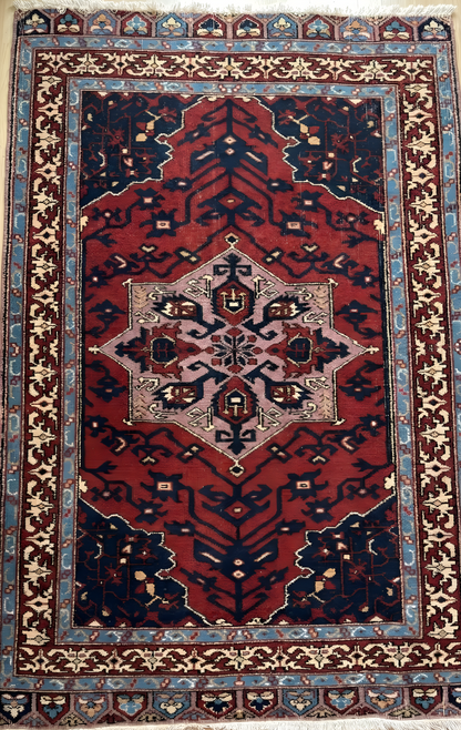 Anatolian wool rug with intricate patterns on a red background