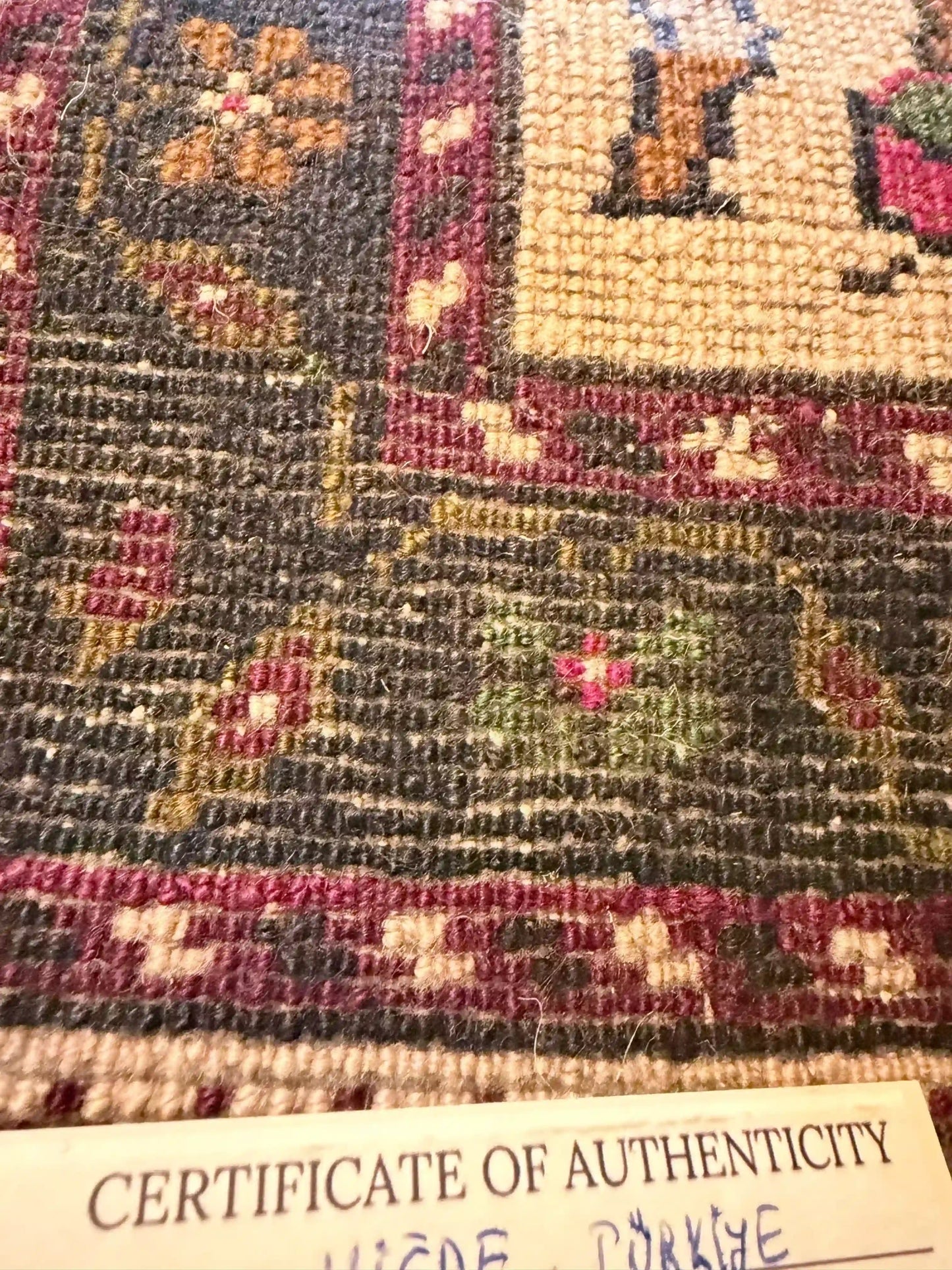 Anatolian wool rug with a 'Certificate of Authenticity' at the bottom.