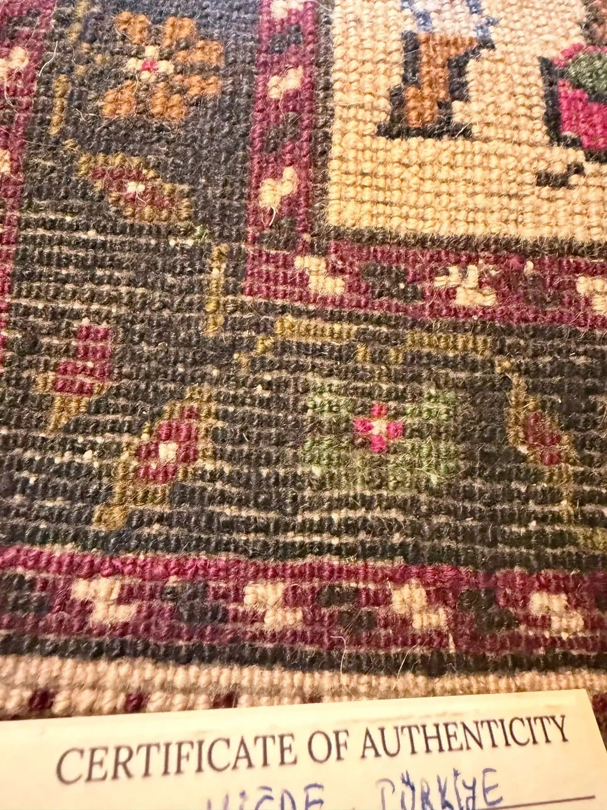 Anatolian wool rug with a 'Certificate of Authenticity' at the bottom.