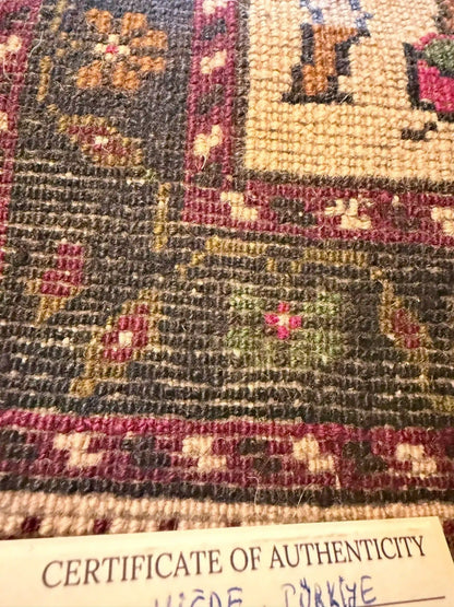 Anatolian wool rug with a 'Certificate of Authenticity' at the bottom.