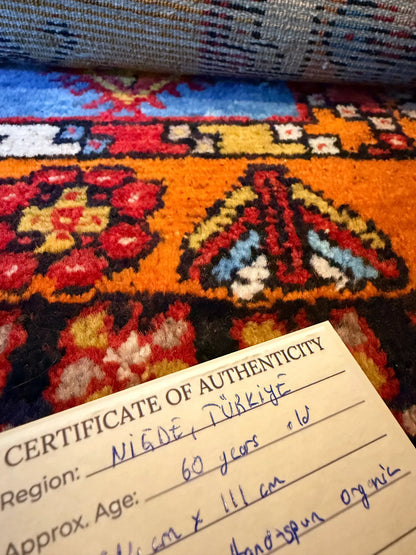 Colorful patterned fabric with a Certificate of Authenticity overlay