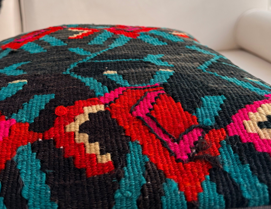Vintage floral kilim cushion cover with vibrant red rose motifs on a deep charcoal hand-spun wool background