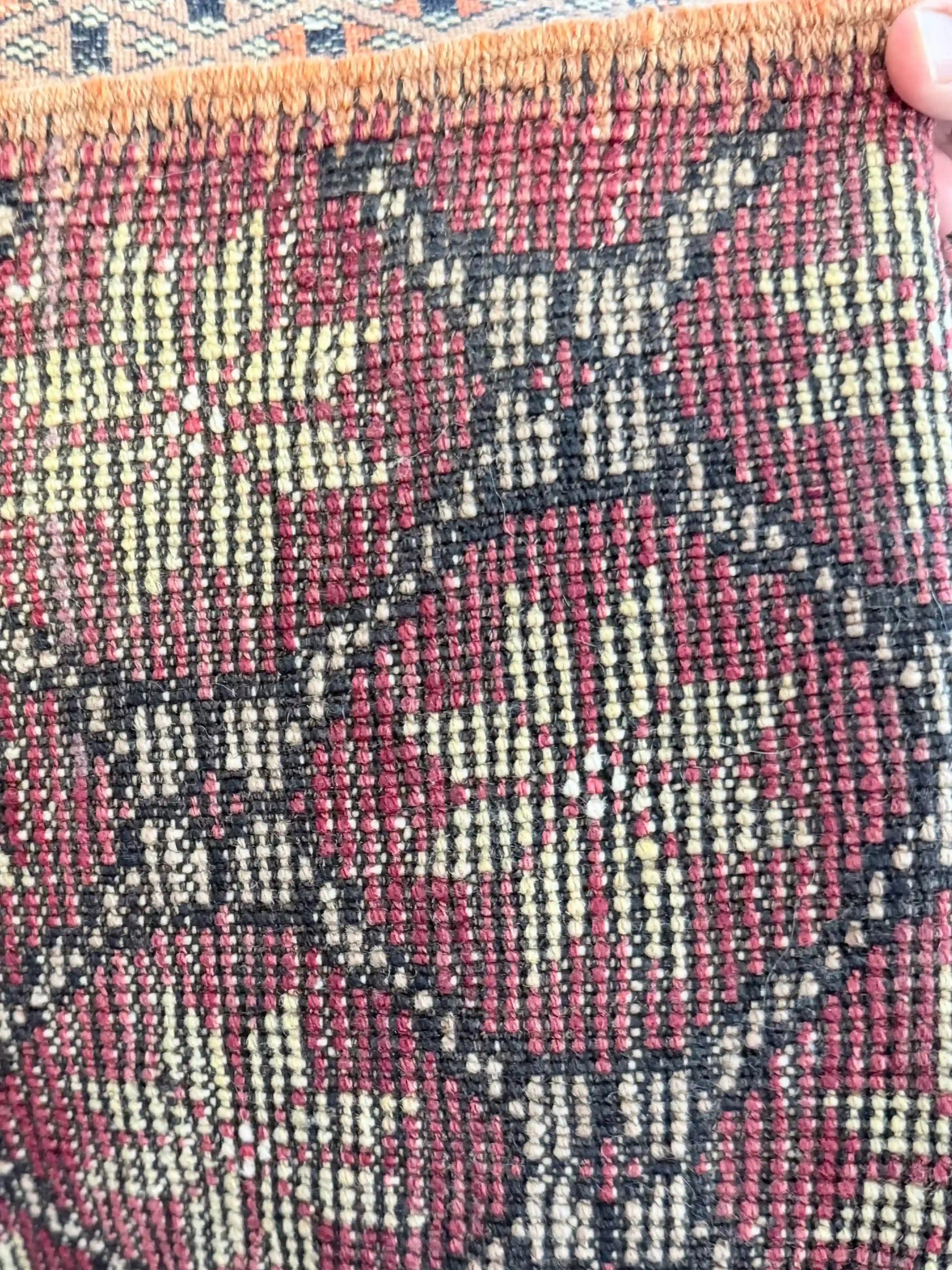 Close-up of a handmade Turkish carpet, hand-knots are visible 
