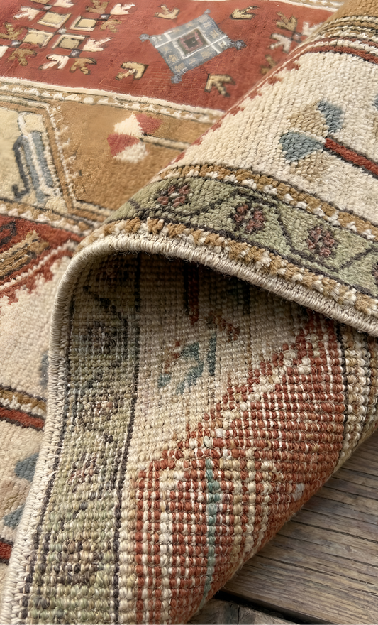 Close-up of a patterned vintage anatolian 100% wool natural dye rug with intricate design