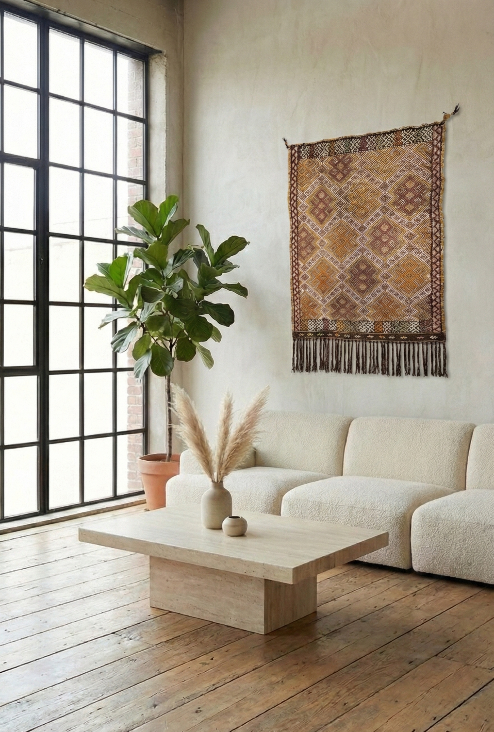 Anatolian woven rug with geometric patterns in warm brown, gold, and rust, in a minimalist living room setting