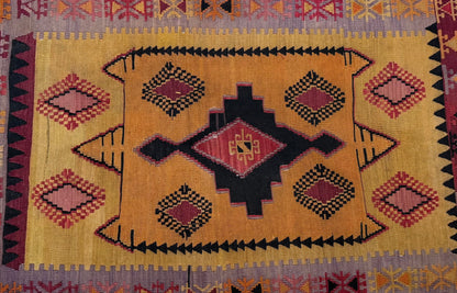 Decorative  Anatolian rug with geometric pattern on a tiled floor