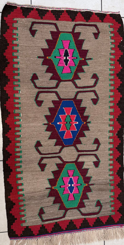 Woven turkish rug with geometric pattern on a tiled floor