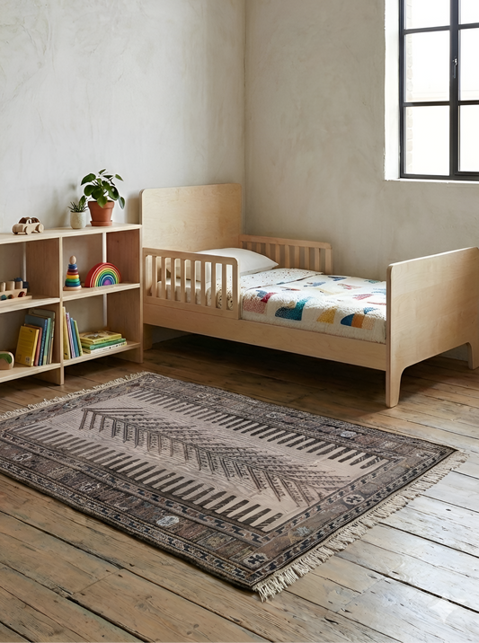 Children's room with a wooden bed, bookshelf, and vintage anatolian 100% wool natural dye flatwoven rug