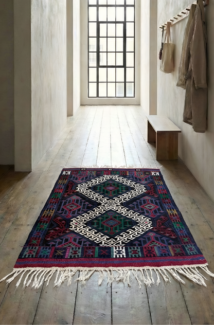 Anatolian kilim rug with geometric pattern on wooden floor with large window