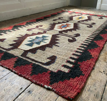 Traditional Anatolian patterned rug on a wooden floor