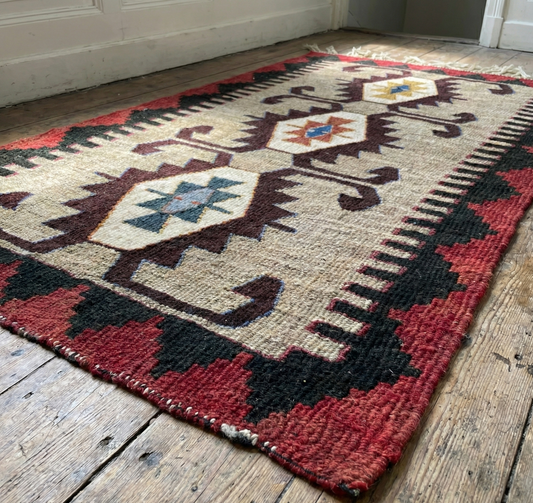 Traditional Anatolian patterned rug on a wooden floor
