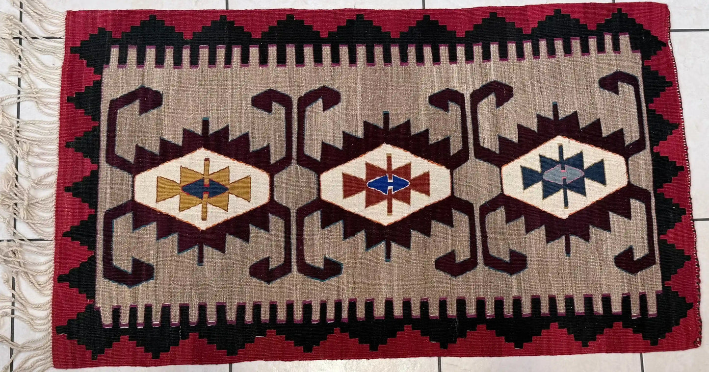 Anatolian kilim rug with geometric pattern on a tiled floor