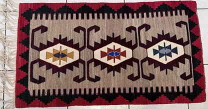 Anatolian kilim rug with geometric pattern on a tiled floor
