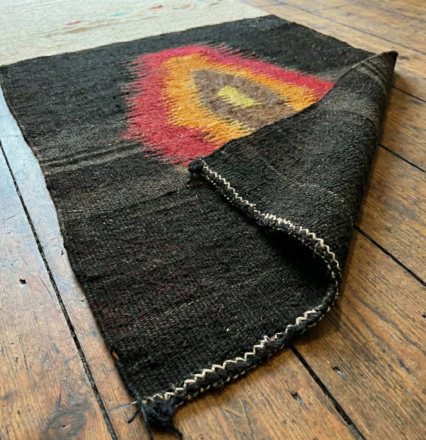Anatolian authentic kilim runner on a wooden surface