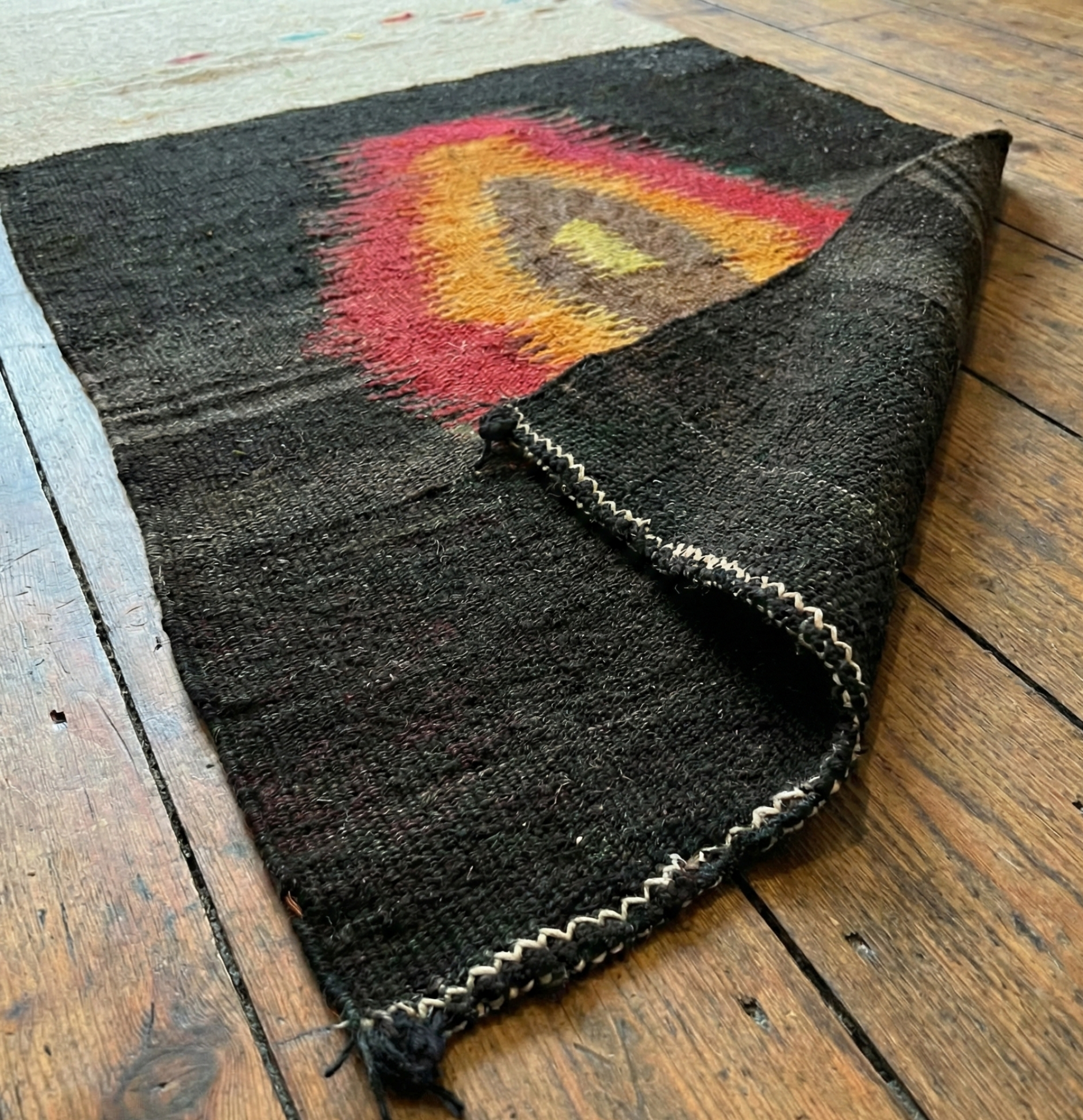 Anatolian authentic kilim runner on a wooden surface
