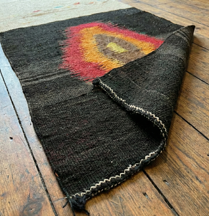Anatolian authentic kilim runner on a wooden surface
