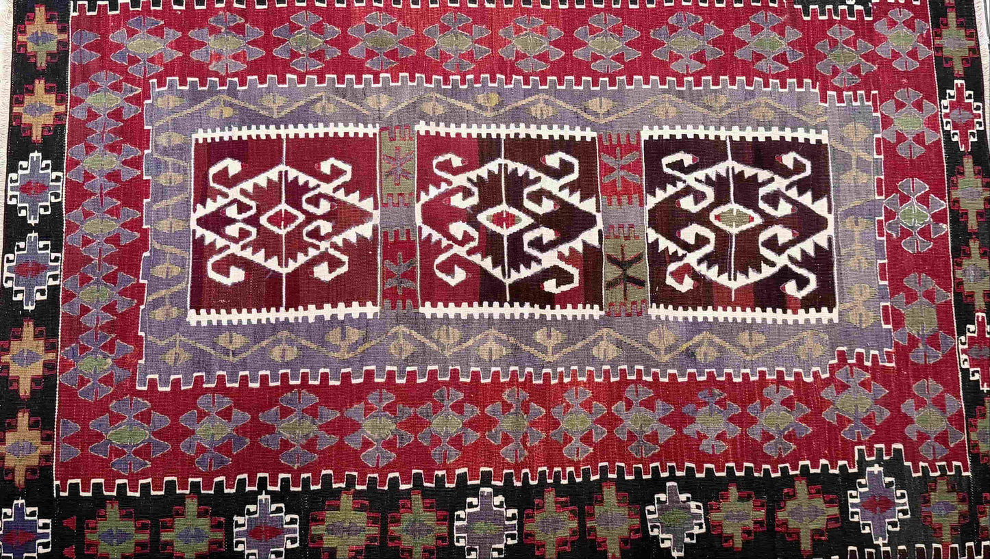 Decorative Anatolian rug with geometric pattern on a tiled floor