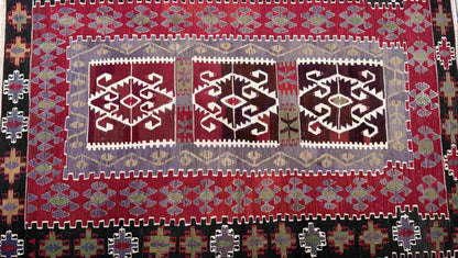 Decorative Anatolian rug with geometric pattern on a tiled floor