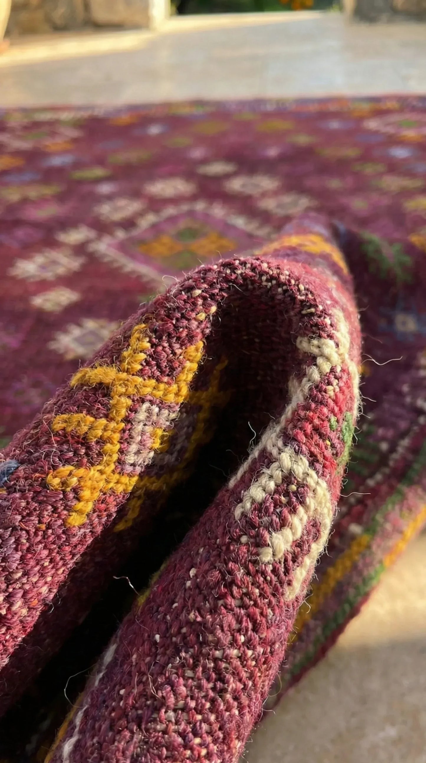Close-up of a textured rug with intricate patterns on a blurred background