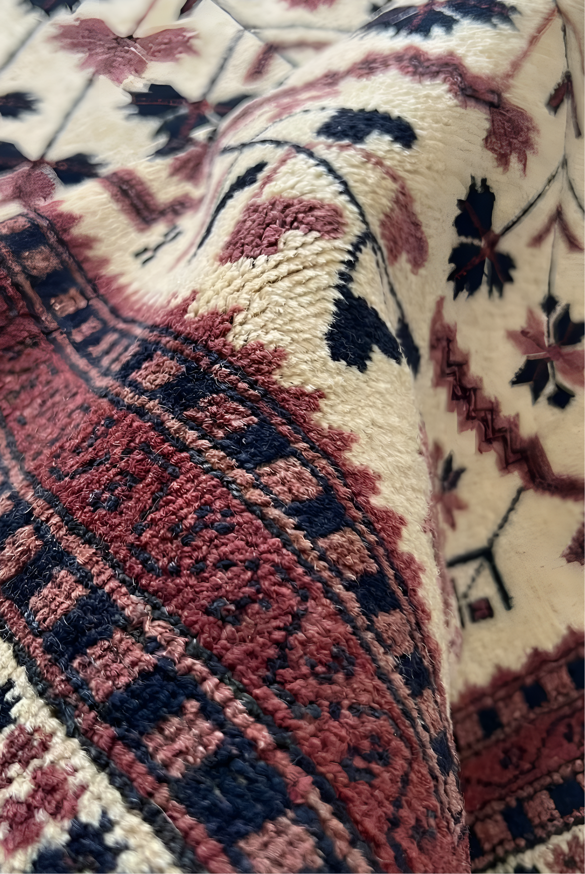 Close-up of an Anatolian rug with red, black, and beige colors