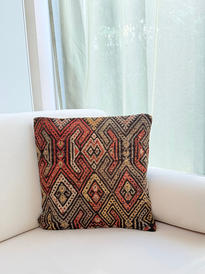 Handwoven Anatolian kilim cushion cover with traditional geometric diamond motifs in terracotta and charcoal wool