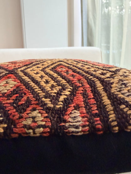 Handwoven Anatolian kilim cushion cover with traditional geometric diamond motifs in terracotta and charcoal wool