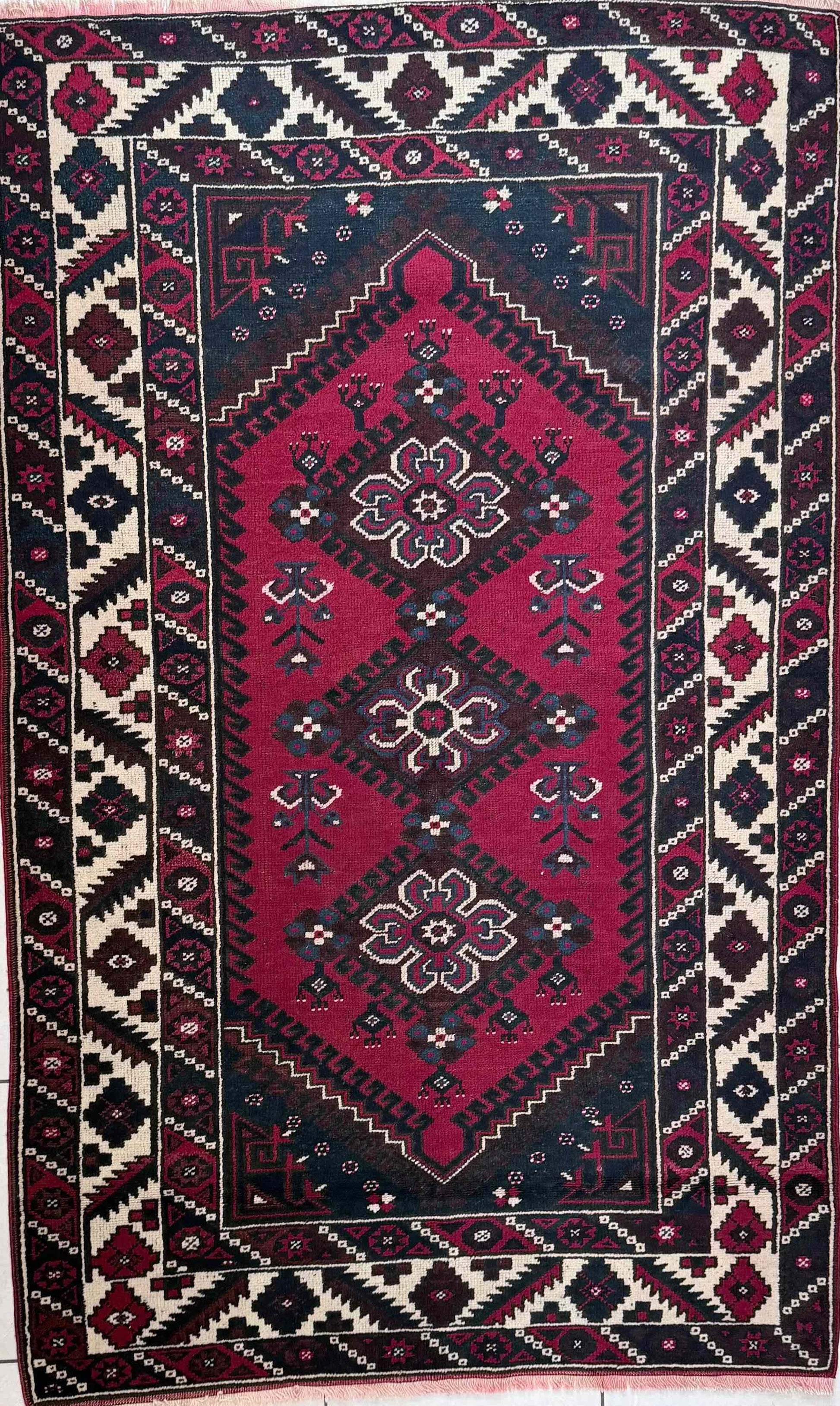 Handknotted wool rug in red, cream and charcoal 