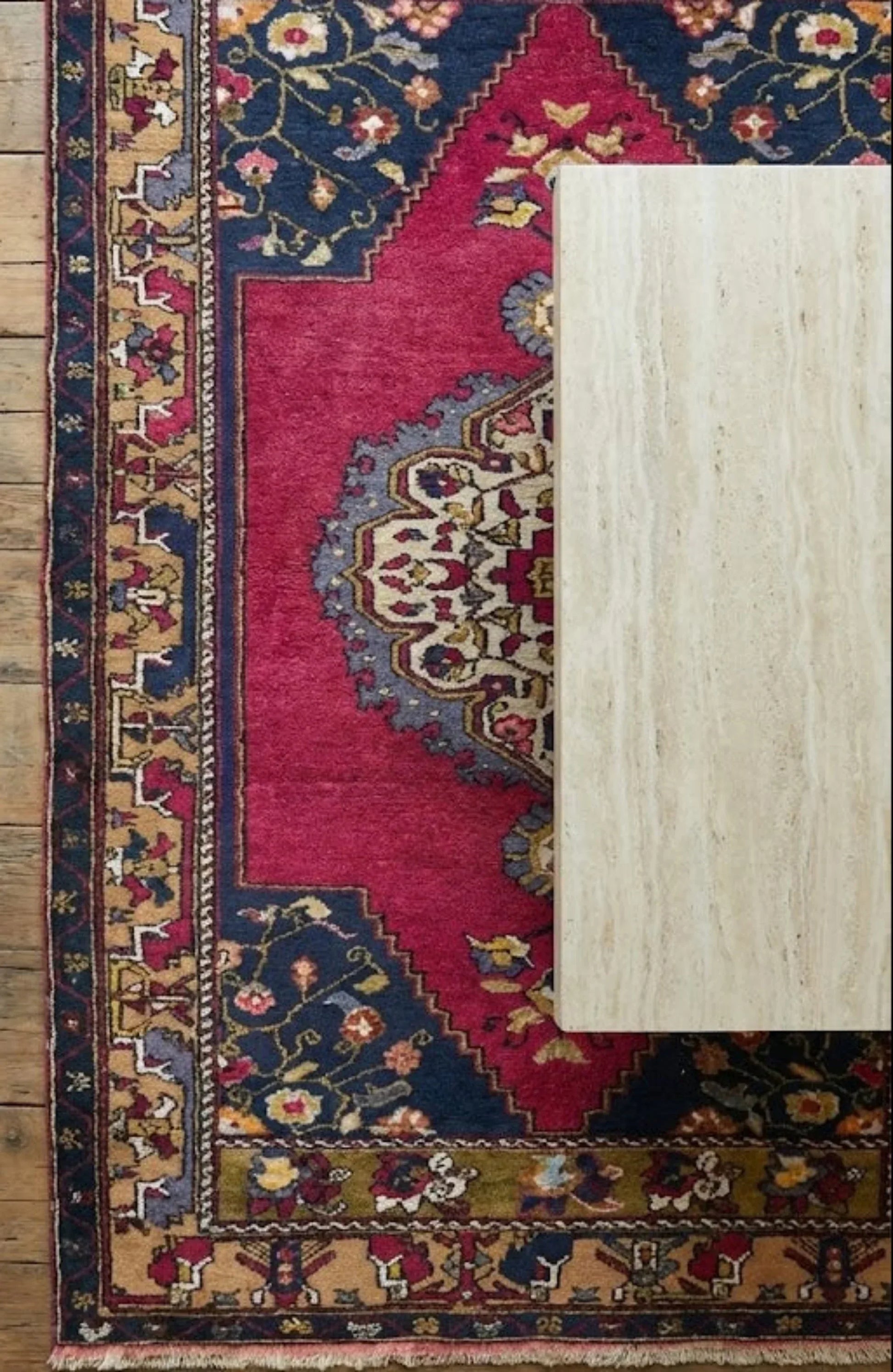 Anatolian wool rug with intricate patterns on a wooden floor